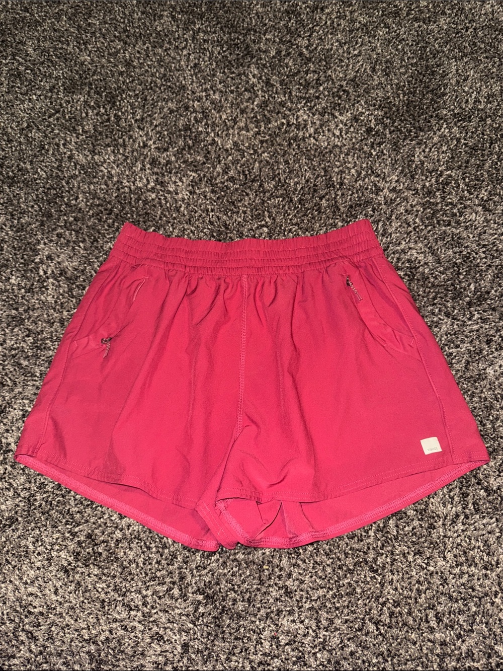 Vuori women's athletic shorts in raspberry
